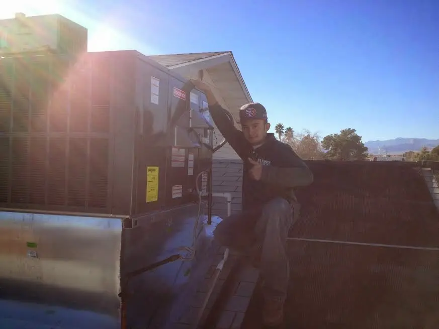 HVAC technician performing Air Duct Repair on a rooftop unit in Union City